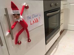 an elf is hanging on the oven door