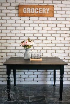 a black table with flowers on it and a sign that says grocery