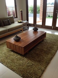 a living room with couches, coffee table and sliding glass doors