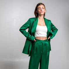 This blazer is tailored from silky viscose and detailed with shoulder pads and a detachable belt. Its oversized silhouette has a loose fit. The androgynous style of the suit adds effortless elegance to the minimal lines, the fine craftsmanship and the cool mood of the design, giving an extra feeling of confidence. Pair it with its matching pleated pants to create the "Confidence suit" of the collection. Cut one by one and hand-tailored by local artisans in our atelier in Athens. 100% Viscose  Dry Clean Only Green Suit Women, Style Androgyne, Suit Collection, Satin Blazer, Roses Are Red, Green Suit, Red Suit, Androgynous Fashion, Silky Blouse