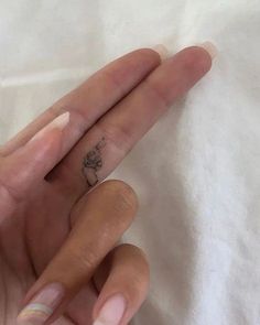 a woman's hand with a small tattoo on it