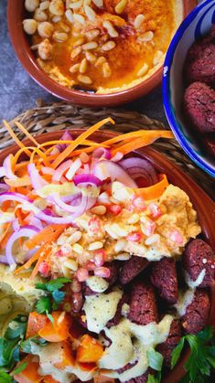 two bowls filled with meat and vegetables next to another bowl full of food on a table