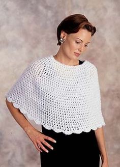 a woman wearing a white crochet top with scalloped edges