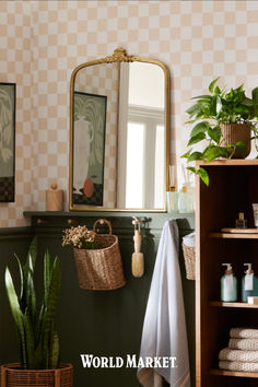 the bathroom is decorated in green and white checkered wallpaper, with a gold framed mirror