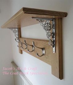 a wooden shelf with metal hooks on it