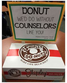 a donut box sitting on top of a table next to a sign that says, donut we do without consolors like you