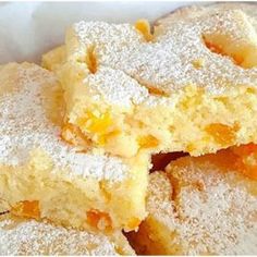 powdered sugar covered desserts stacked on top of each other in a white bowl