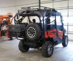 an orange and black vehicle parked in a garage