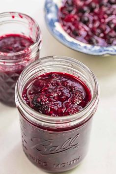 two mason jars filled with blueberry sauce