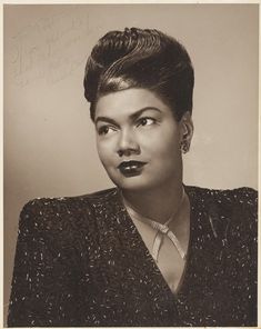 an old black and white photo of a woman with dark lipstick on her lips, looking at the camera