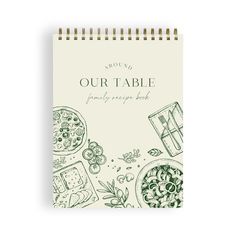 a spiral notebook with the words our table printed on it and illustrations of different foods