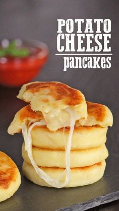 there is a stack of pancakes with cheese on top and the words potato cheese pancakes above it