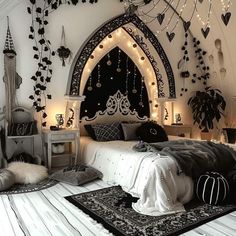 a bedroom decorated in black and white with lots of lights