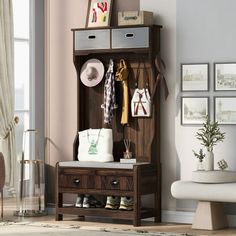 an entryway with a bench, coat rack and shoes on the floor in front of a window