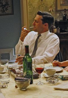 a man and woman sitting at a dinner table