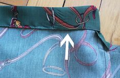 the side of a piece of fabric with an arrow pointing to it