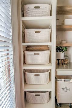 the closet is organized with baskets and other items