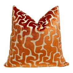 an orange and white pillow on a white background