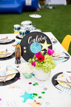 a table set up for a celebration with plates and confetti