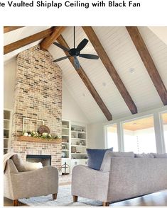 the ceiling fan is hanging in front of the fireplace