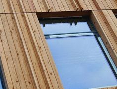 an image of a window on the side of a building that is made out of wood