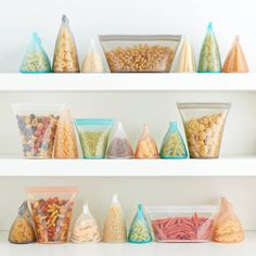 shelves filled with different types of cereal and other food in plastic bags on top of them