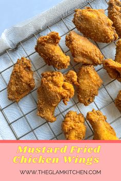 fried chicken wings on a cooling rack with text overlay that reads mustard fried chicken wings