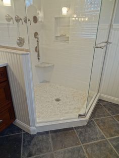 a walk in shower sitting inside of a bathroom