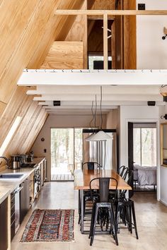 a kitchen and dining room area with an arrow pointing to the right in front of it