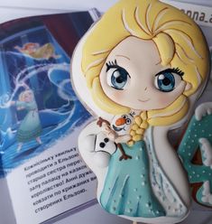 there is a cake shaped like a frozen princess holding a snowman on top of it