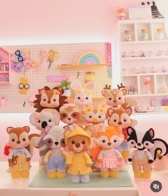 a group of stuffed animals sitting on top of a white table next to each other