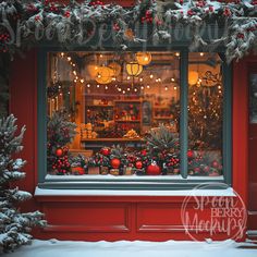 a storefront with christmas decorations and lights on it's windowsill in the snow