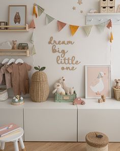 Wooden 'dream big little one' wall word sign in a script style font in a kids room displayed on a white wall, with pastel coloured accessories. Above Cot Decor, Kids Neutral Bedroom, Toddler Room Wall Decor, Toddler Wall Decor, Quirky Nursery, Nursery Books, Nursery Room Wall Decor, Baby Room Signs, Workshop Decor