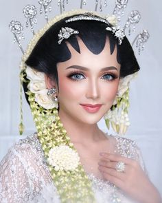 a woman wearing a tiara with flowers on her head