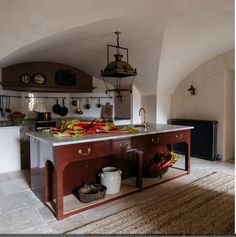 a kitchen with an island in the middle and lots of food on top of it