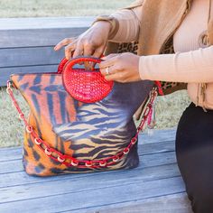 Bag Size Approx.: 13.5 x 12 x 5.5 inches | Handle Length Approx.: 1.5 inches | Chain Sling Approx.: 25 inches | Long Sling Approx.: 50 inches Stylish "Hybrid" handbag features a mixed animal print motif of tiger and leopard. It features a circle handle made out of faux red crocodile. If you want to change it up, you can also attach the chain sling handle trimmed in crimson and gold. LARGE CAPACITY! This bag can hold an iPad, charger, wallet, notebook, keys, makeup and other personal belongings w Handheld Satchel With Chain Strap For Shopping, Shopping Satchel With Chain Strap And Double Handle, Shopping Satchel With Double Handle And Chain Strap, Double Handle Satchel With Chain Strap For Shopping, Everyday Tote Bag With Chain Strap, Rectangular Bags With Chain Strap For On-the-go, Travel Tote Bag With Chain Strap, Top Handle Satchel With Chain Strap For Travel, On-the-go Satchel Bag With Chain Strap