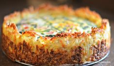 a cheesy quiche with cheese and other toppings