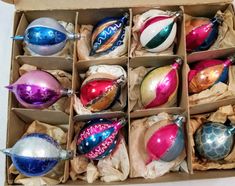 an open box filled with assorted christmas ornaments