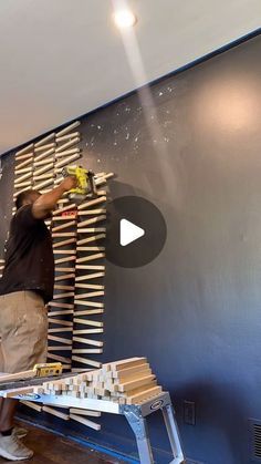 a man is painting the wall in his room with blue walls and white trimmings