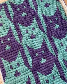 a crocheted blanket with cats on it