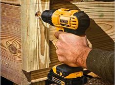 a man using a drill to attach wood