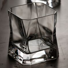 a glass vase sitting on top of a wooden table