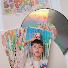 a cd with an image of a boy holding his hand up to the top of his head