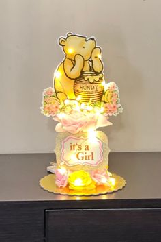 a winnie the pooh birthday cake with lights