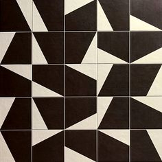 a black and white tile pattern is shown in the middle of an image with multiple triangles on it