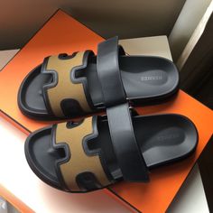 Hermes H Logo Black And Khaki Leather Chypre Sandals Flats Brand New With Box Size 41.5. With The Box And 2 Dust Bags. 100 % Authentic. Have The Proof Of Purchase From Poshmark. Luxury Sandals With Leather Trim For Summer, Luxury Leather Trim Sandals For Summer, Designer Open Toe Sandals With Leather Trim, Luxury Black Calf Leather Slides, Designer Calf Leather Slides With Round Toe, Designer Slides With Leather Lining And Round Toe, Luxury Leather Sandals With Leather Trim, Luxury Black Sandals With Rubber Sole, Luxury Black Slides With Leather Sole