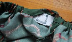 a close up of a cloth with a tag on it's back pocket,