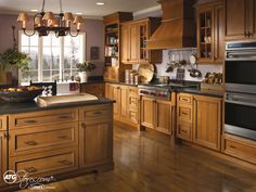 a kitchen filled with lots of wooden cabinets and counter top space next to a window