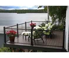 a deck with chairs and flowers on it