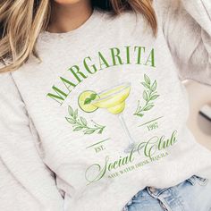 Elevate your style with the Margarita Social Club Crew Sweatshirt, a chic tribute to laid-back sophistication. Featuring a vivid margarita glass design, this exclusive sweatshirt is available in trendy colors: white, pink, ash, and ivory. Embrace comfort and fashion with this versatile piece, perfect for casual outings or stylish social gatherings. Crafted for year-round wear, the Margarita Social Club Crew Sweatshirt blends iconic imagery with a contemporary aesthetic, making it a must-have for those who appreciate the finer things in life. Cheers to style and leisure! Design is Printed Direct to Garment. See Size Guide for Unisex Crew Sweatshirt in photos We recommend comparing these measurements against a sweatshirt that you like the fit of for ordering a sweatshirt that will fit best. Cocktail Club, Plus Size Shopping, Social Club, Crew Sweatshirts, Turks And Caicos Islands, Heavy Fabric, Unisex Sweatshirt, Long Sleeve Sweater, Crewneck Sweatshirt